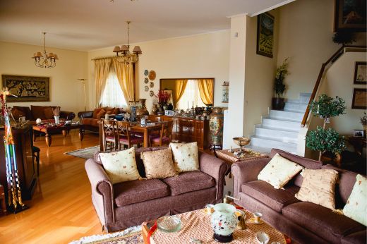 Casa Cinque living room with sofas wooden floor and warm traditional decor