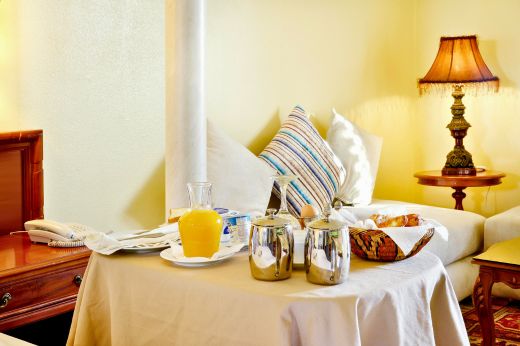 Breakfast tray with orange juice in a Casa Cinque bedroom