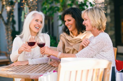 Guests enjoying red wine outdoors in a relaxed hospitality setting